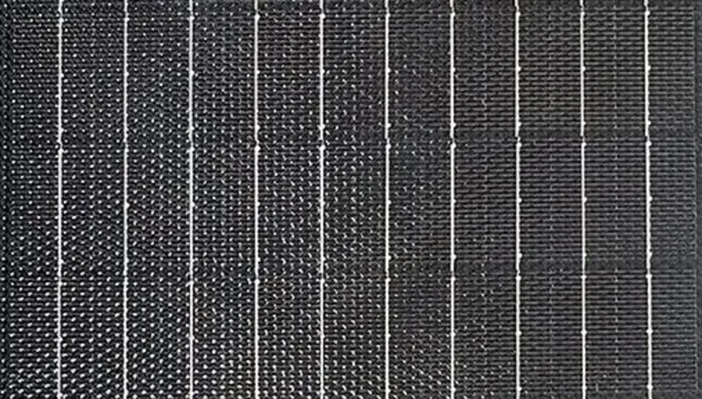 Detail of the embossed pattern on solar module glass showing a fine regular grid structure
