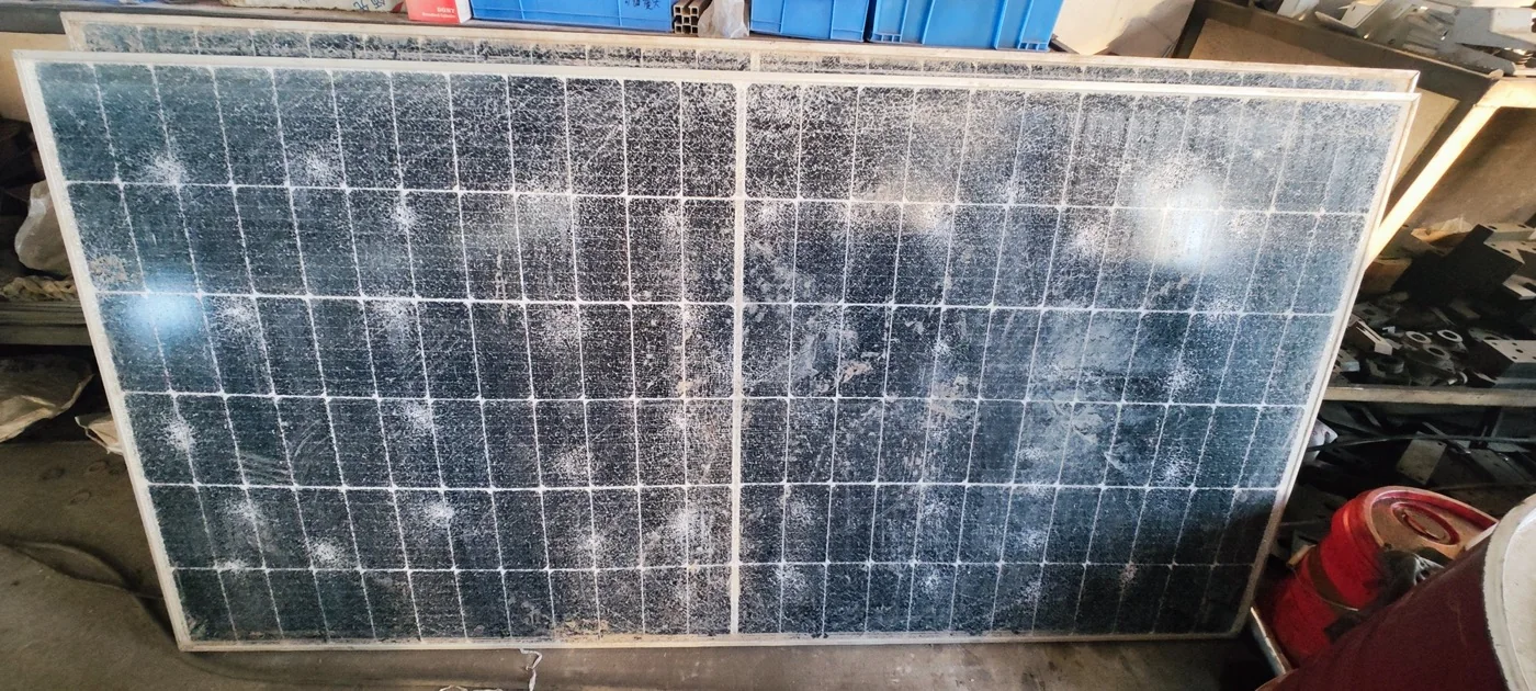 Dirty used solar panel leaning in storage